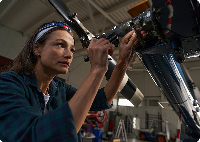 Mechanic repairing an aircraft part in the hangar